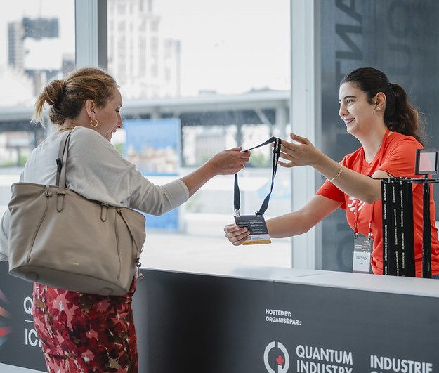 women receiving her name badge at QUANTUM NOW hosted by Quantum Industry Canada (QIC) in partnership with Distriq