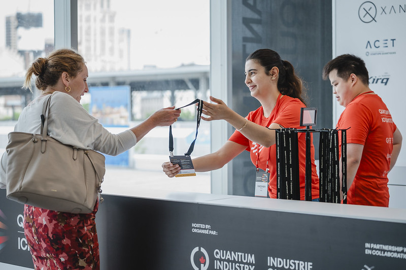 woman receiving her name badge at QUANTUM NOW hosted by Quantum Industry Canada (QIC) in partnership with Distriq